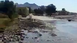 Scooter rider has some fun with water covered road