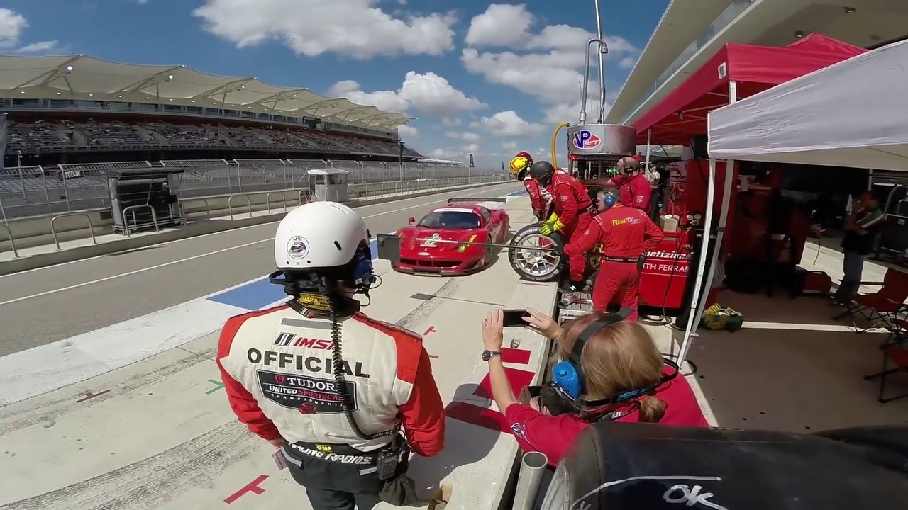 Pit crew drops a Ferrari 458 Italia GT2 on track during pit stop