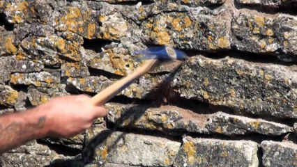 Raking or chopping out joints in stone walls for repointing