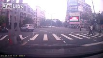 SUV runs a red and takes down a motorbike and scooter rider