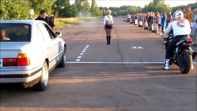 Rider crashes his Motorcycle at line-race start against BMW car