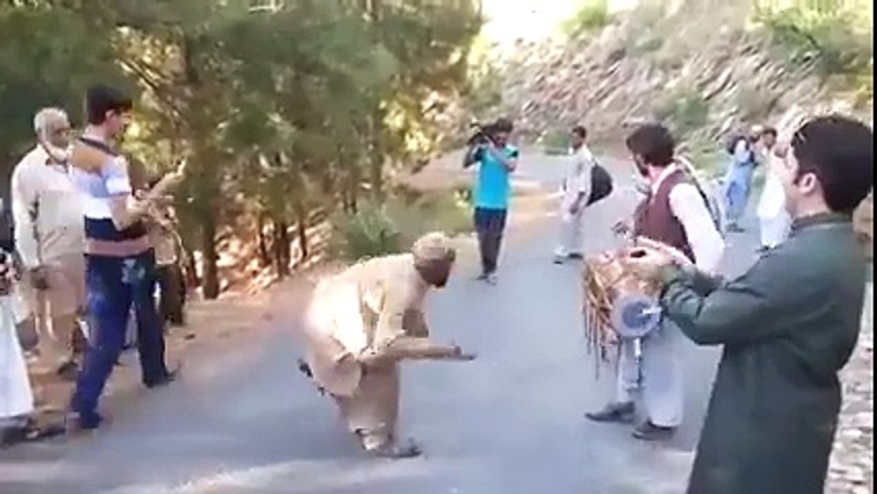 Pathan dancing on road.