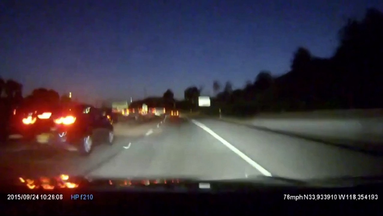Cyclist rides tall bike down middle of US freeway