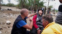 Exhausted Syrian boy taken across border in wheelchair