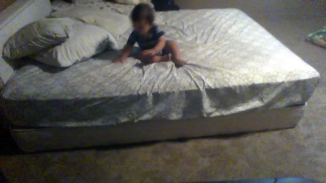 Smart baby throws down pillows to get off a higher bed