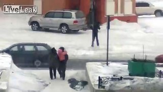 People try to cross the street in Norilsk Russia during winter storm.