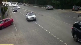 Biker Slams into Turning Car and Almost Flips It !
