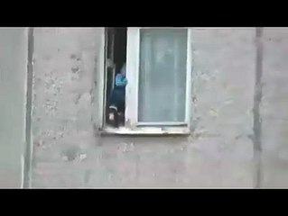 Footage captures toddler playing on eighth floor window sill
