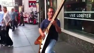 Man Plays a Giant Flying-V Guitar