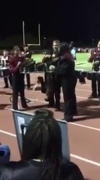 Marchnig band drummer starts playing head upside down