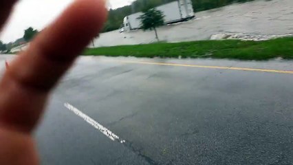 Un camion circule sur une route complètement inondée