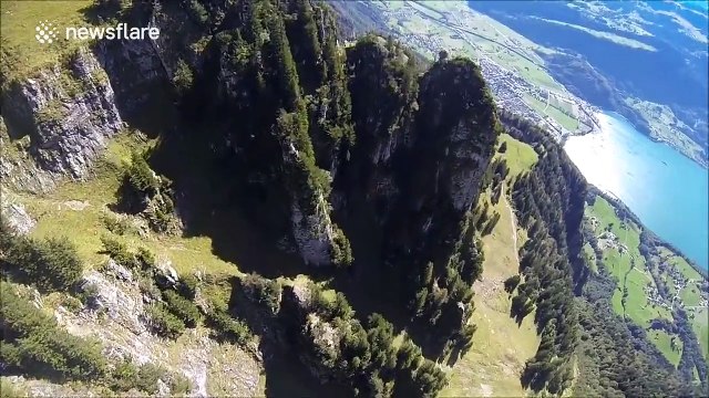 Footage of wing suit flight through tight trench