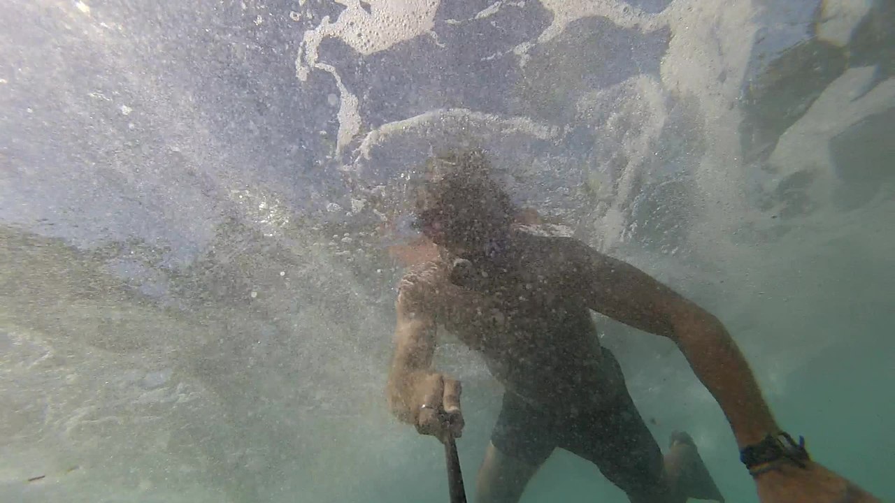 Dangerously tight squeeze diving underneath caves