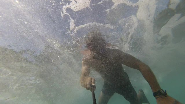 Dangerously tight squeeze diving underneath caves