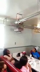 Restaurant serves clients with mini train riding above their heads