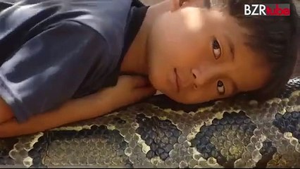 brave boy playing with snake
