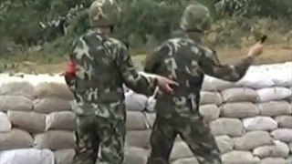A soldier misses his throw grenade and is saved by his instructor