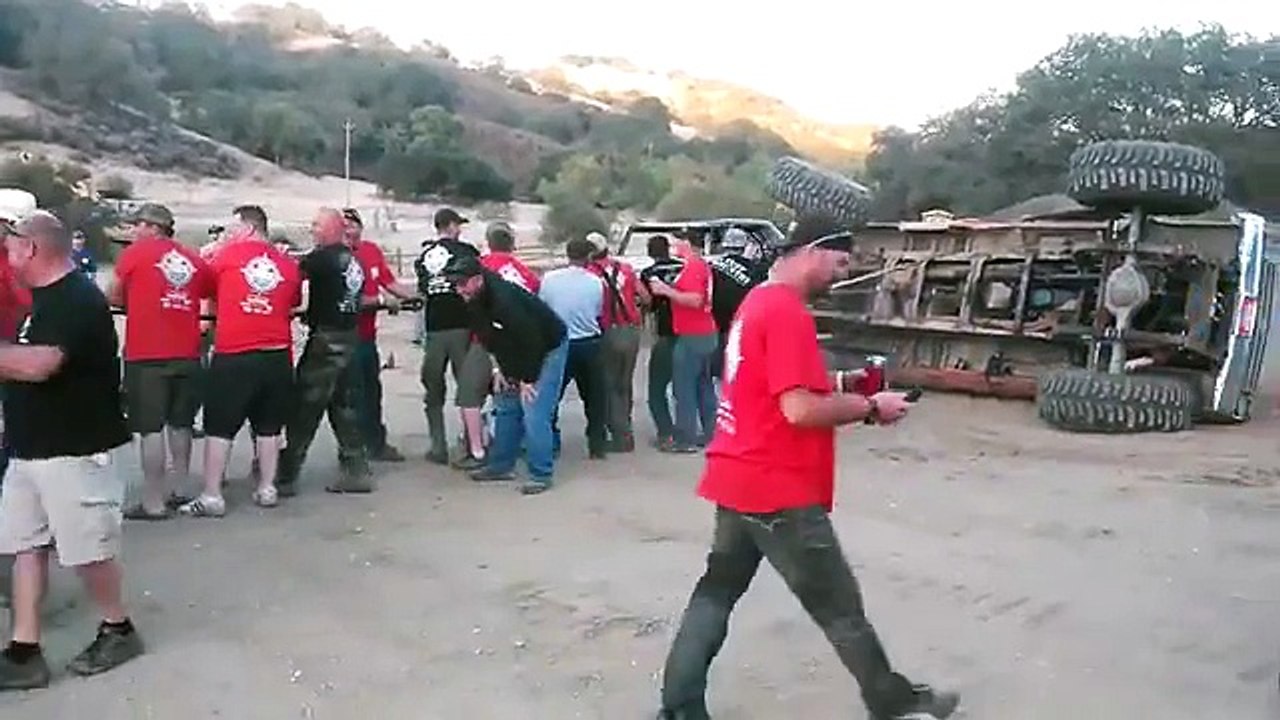 60 People Help Flip Over Flipped Truck By Pulling On Rope