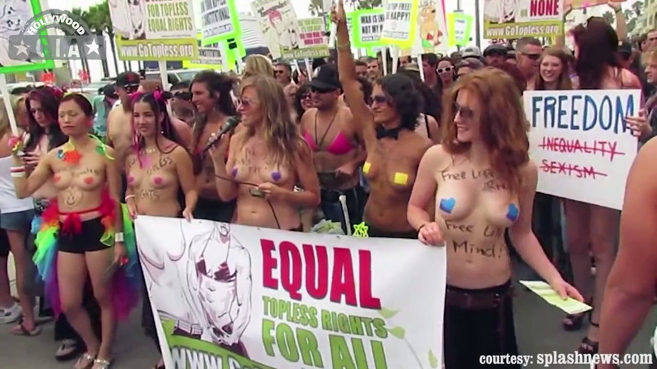 Topless Women parading on the beach