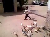 Funny Kid Having Food in the Hand Chased by the Chickens
