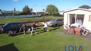 Four guys jump through a moving hula hoop