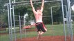 Talented athlete does pull-ups while hula hooping