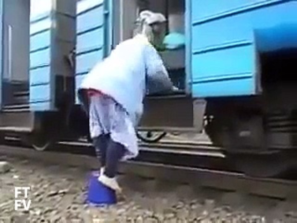 Old woman getting on a train using bucket Thug...