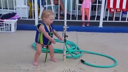 Adorable cute Baby Girl Battles The Water Hose