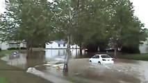 Woman tries to drive through flood water