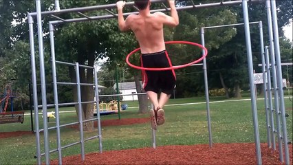 Talented athlete does pull-ups while hula hooping