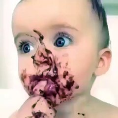 on a baby with a tub of chocolate pudding