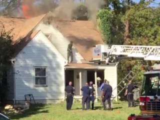 Man barricaded himself in home stands on roof