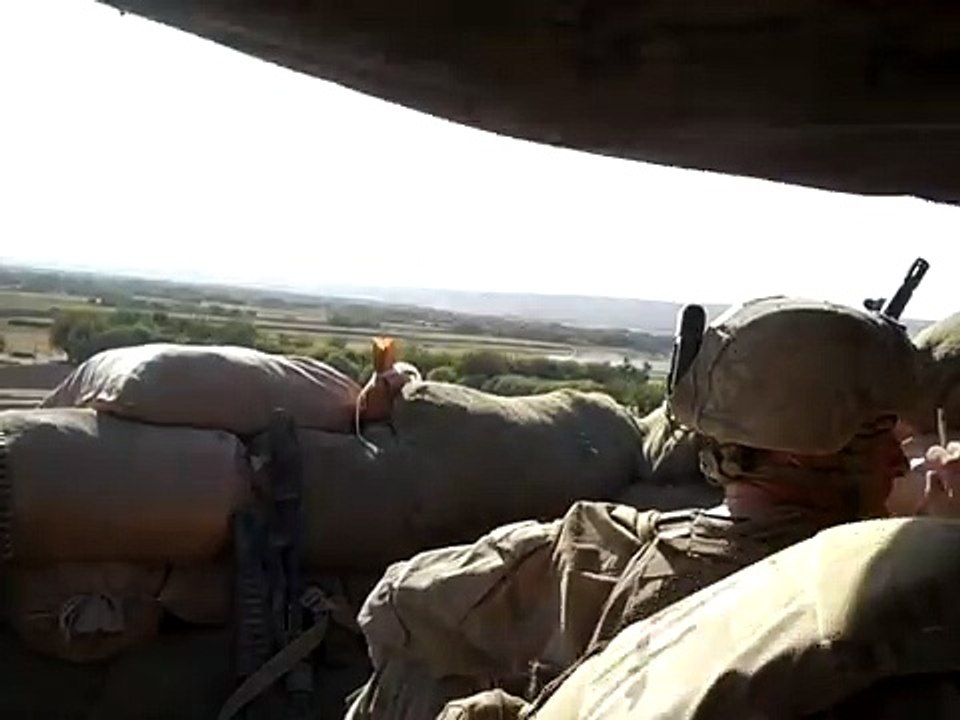 Two Marines in Afghanistan are narrowly missed by a rocket.