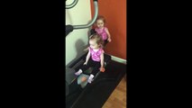 Twin girls take over elliptical machine