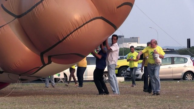 Demonstrators inflate balloon caricature of Brazil's Rousseff