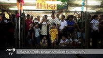 Malaysia's Taoist devotees walk on burning coals