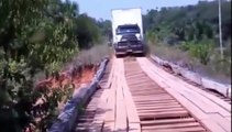 Heavy truck attempts to cross an old wooden bridge