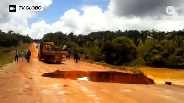 This bus gets swallowed by a sinkhole and swept away