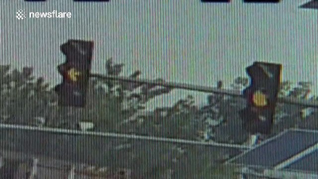 Motorcyclist slides across road after crash... misses lorry by inches