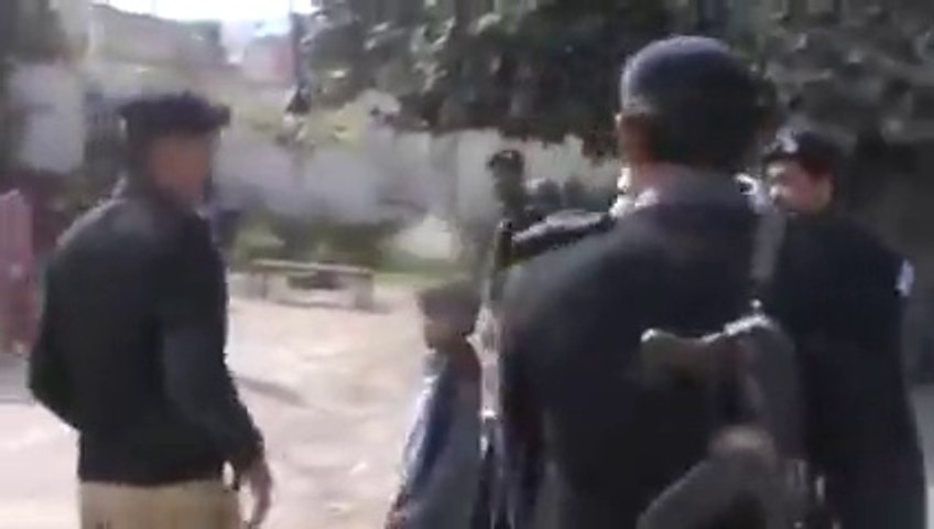 Police beating a women on road