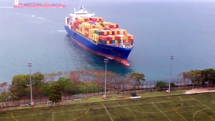 Container ship sails straight to shore by university football field