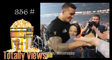 Winner of the rugby world cup gives the gold medal to a boy jumping into the field