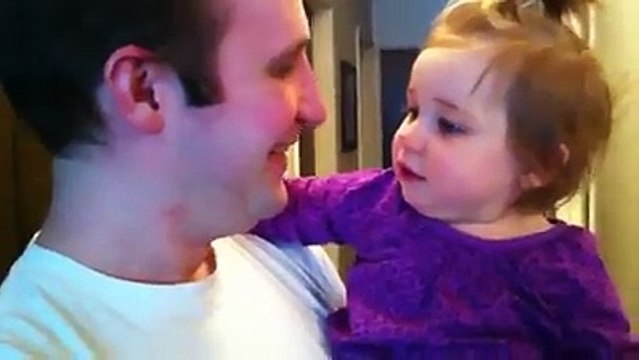 A toddler gets a big surprise when her father shaves his beard
