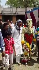 groom covered with flowers