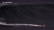 British surfer Andrew Cotton tackles a huge wave in Nazare, Portugal