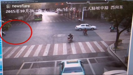 Seven-year-old rides scooter with dad on the back seat during rush hour