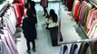 Woman caught on camera sneaking coat under her top in clothes shop