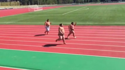 Sumo Wrestlers Running a Race