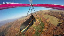 This is what hang gliding over a beautiful forest in Autumn looks like