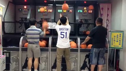 A man throwing basketballs at the attraction without a miss